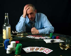 man gambling and drinking